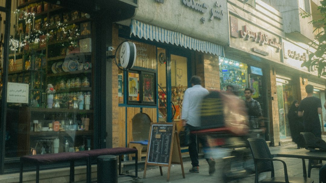 Neighborhood storefront and passing delivery rider