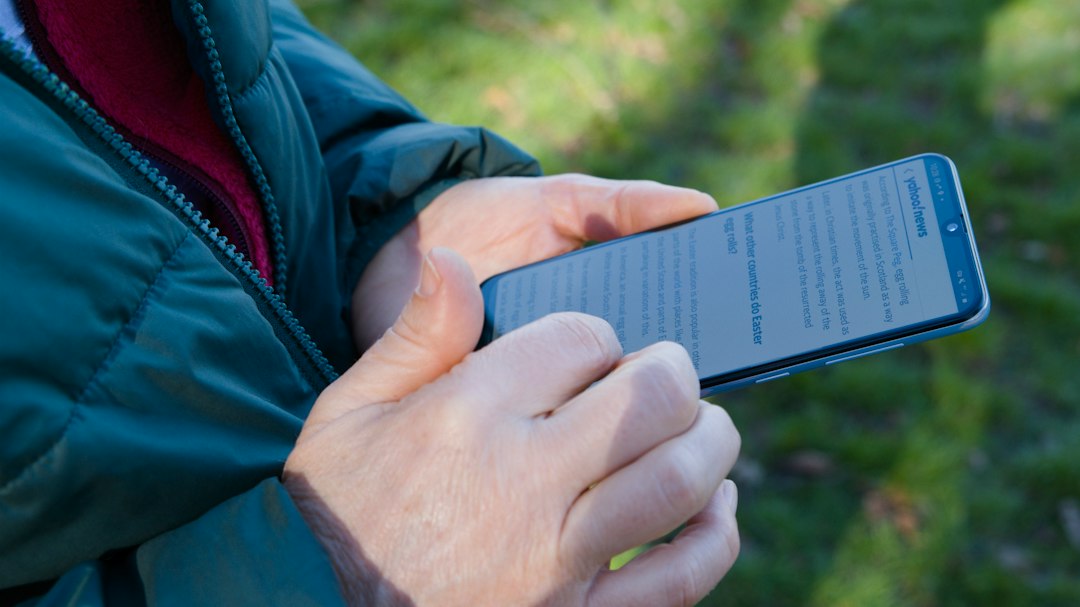 Person checking a website on a smartphone outdoors