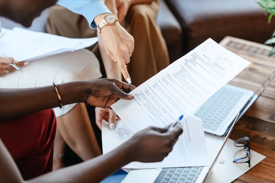 Small business colleagues reviewing documents to compare marketing investments